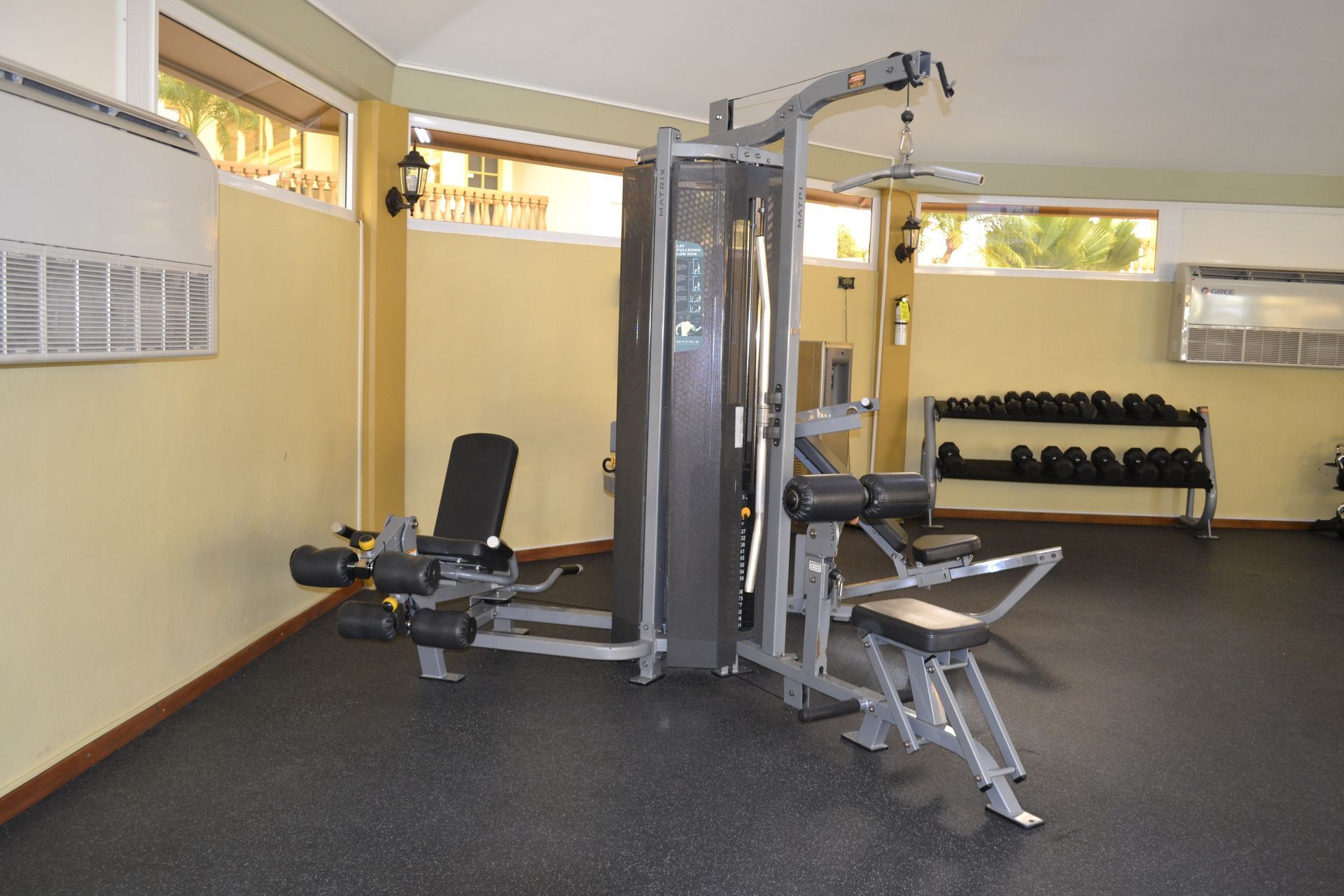 A gym with a lot of equipment and a window