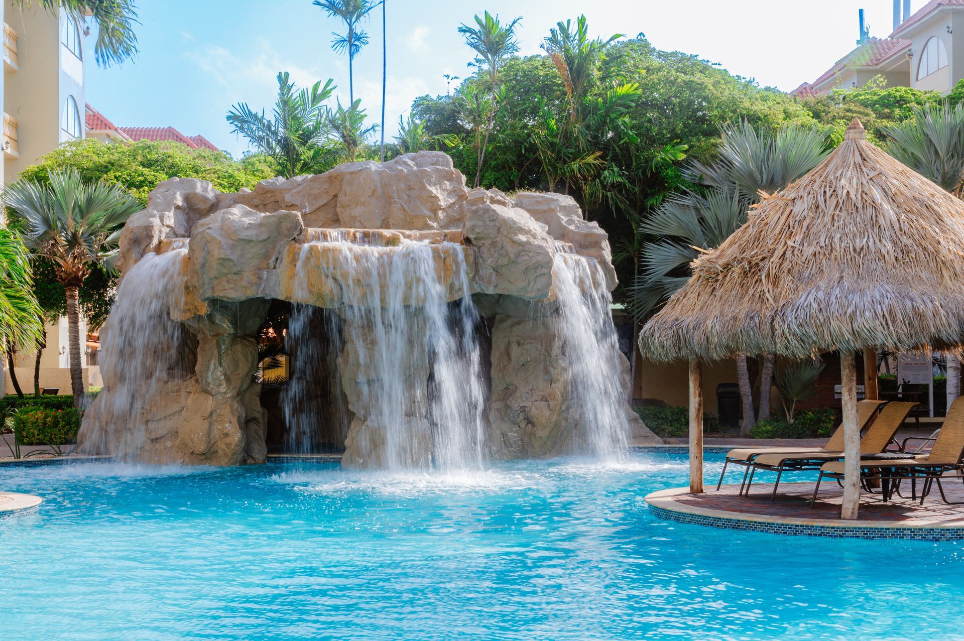 There is a waterfall in the middle of the pool.
