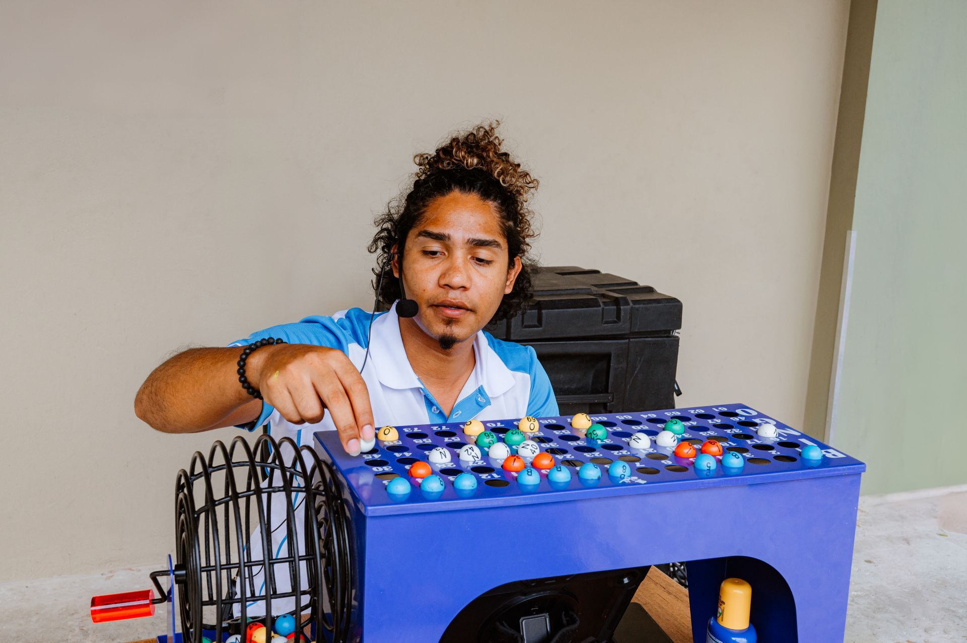 A man is playing a game of bingo on a table.