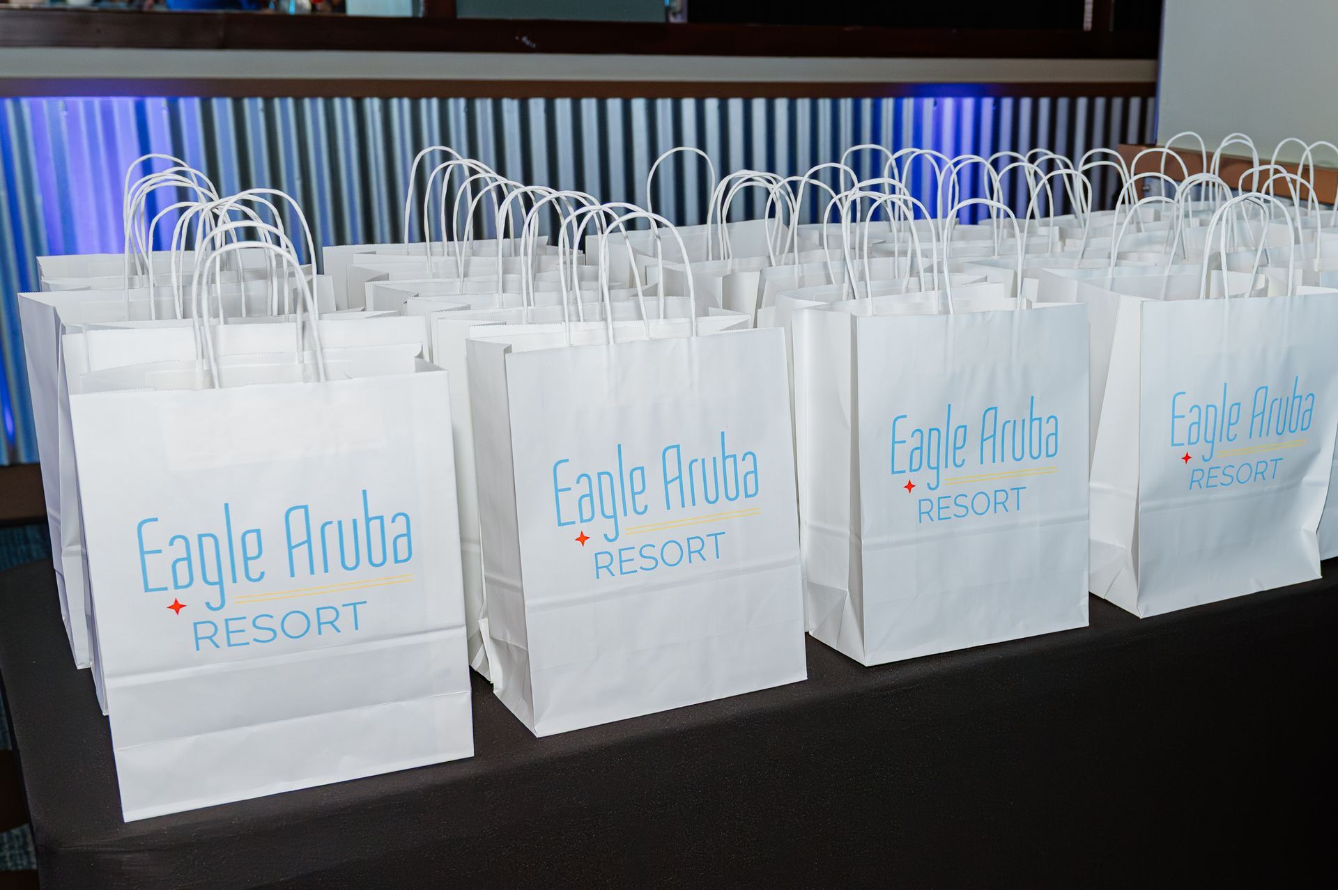 A table topped with white bags that say eagle aruba resort
