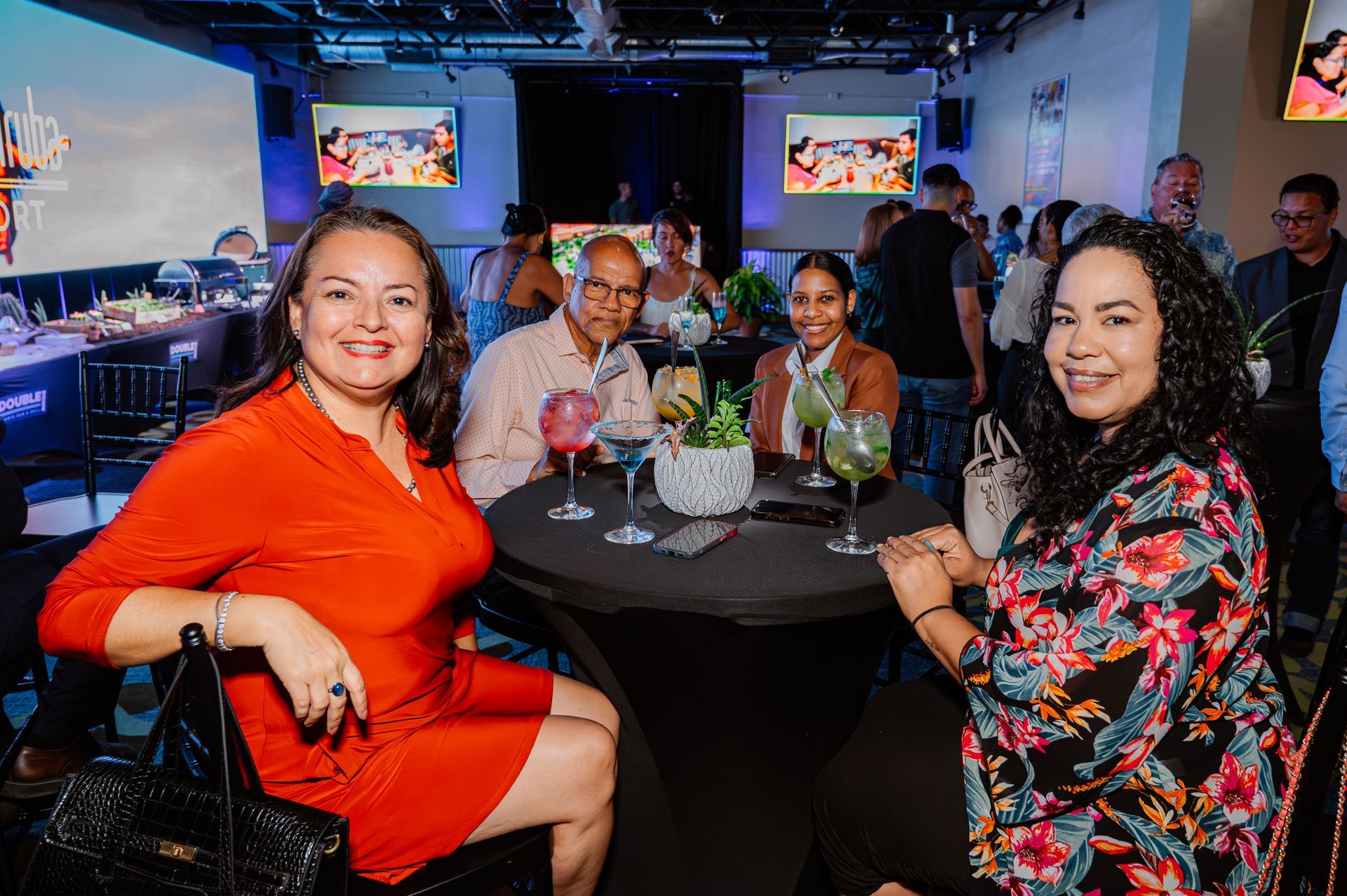 A group of people are sitting at a table with drinks.