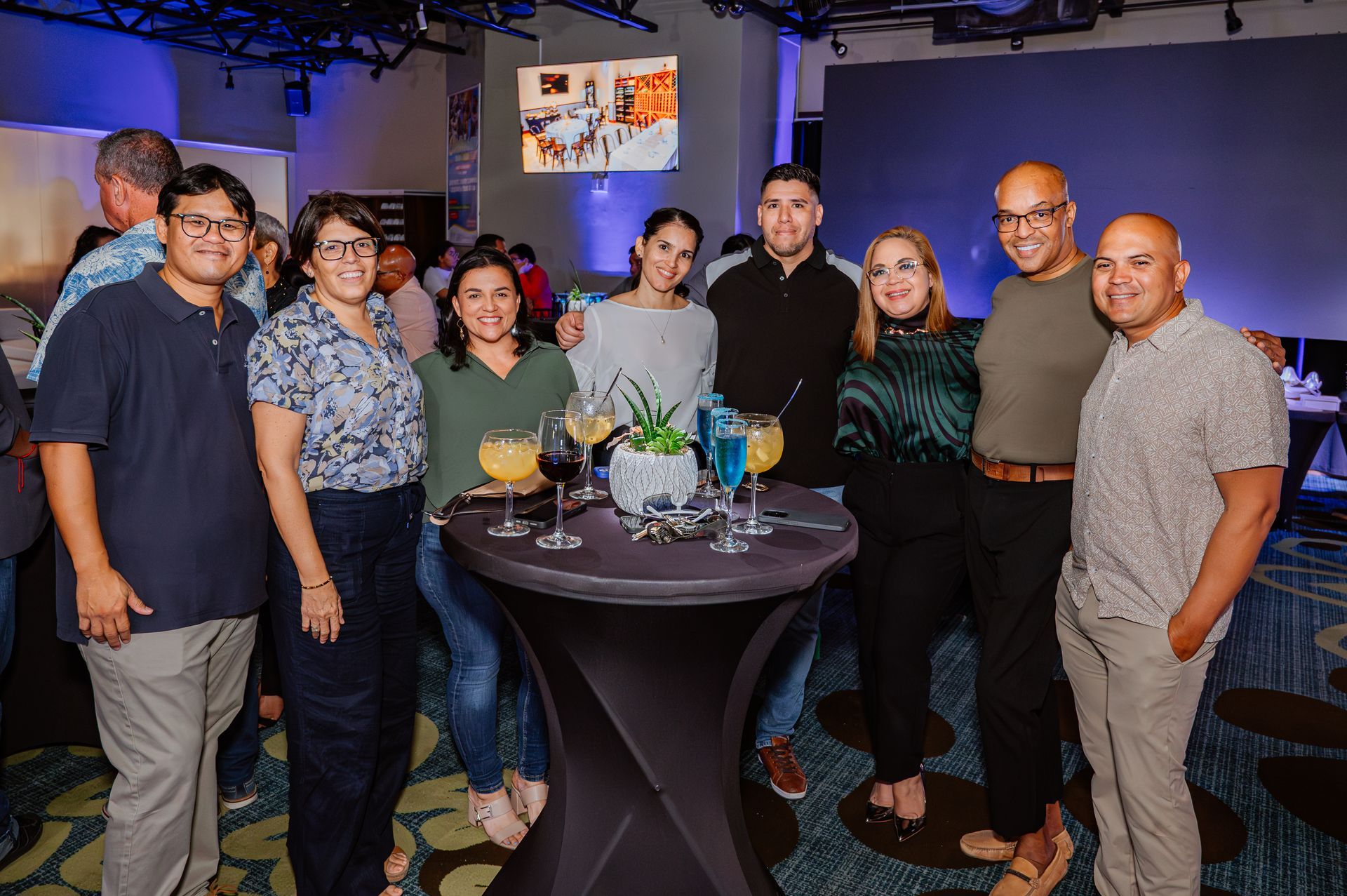 A group of people are posing for a picture at a party.