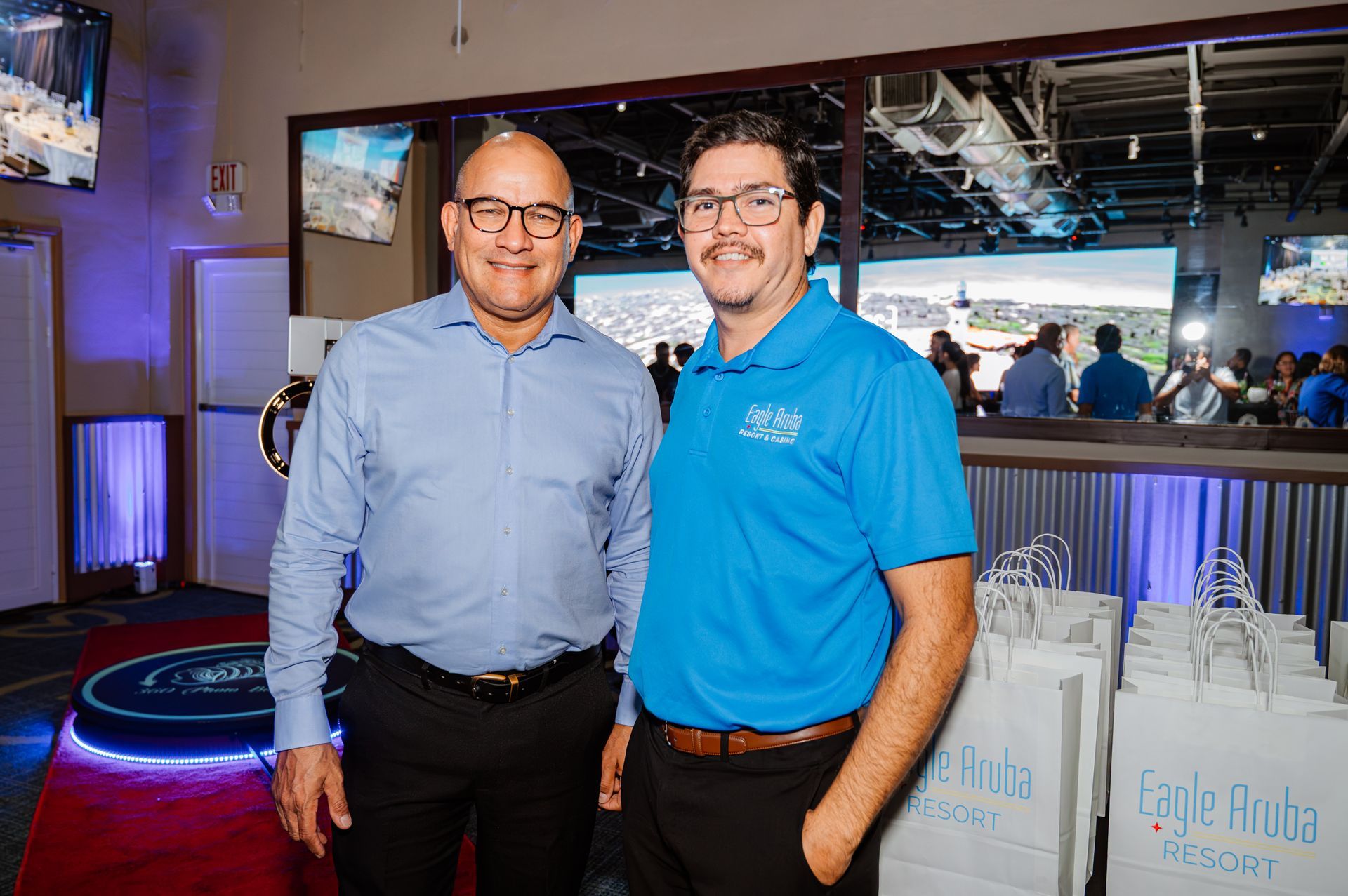 Two men are standing next to each other in a room.