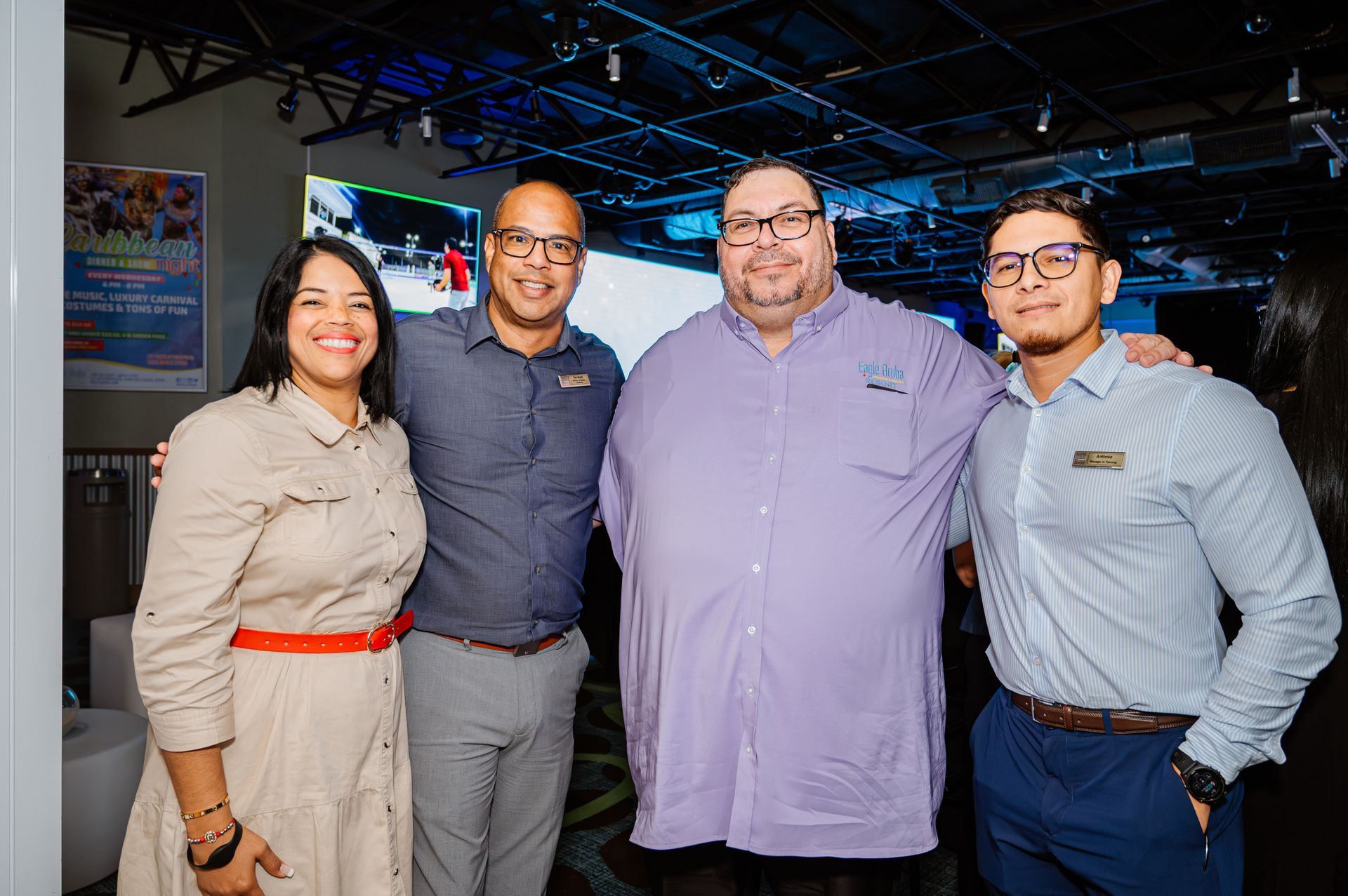 A group of people are posing for a picture together in a room.