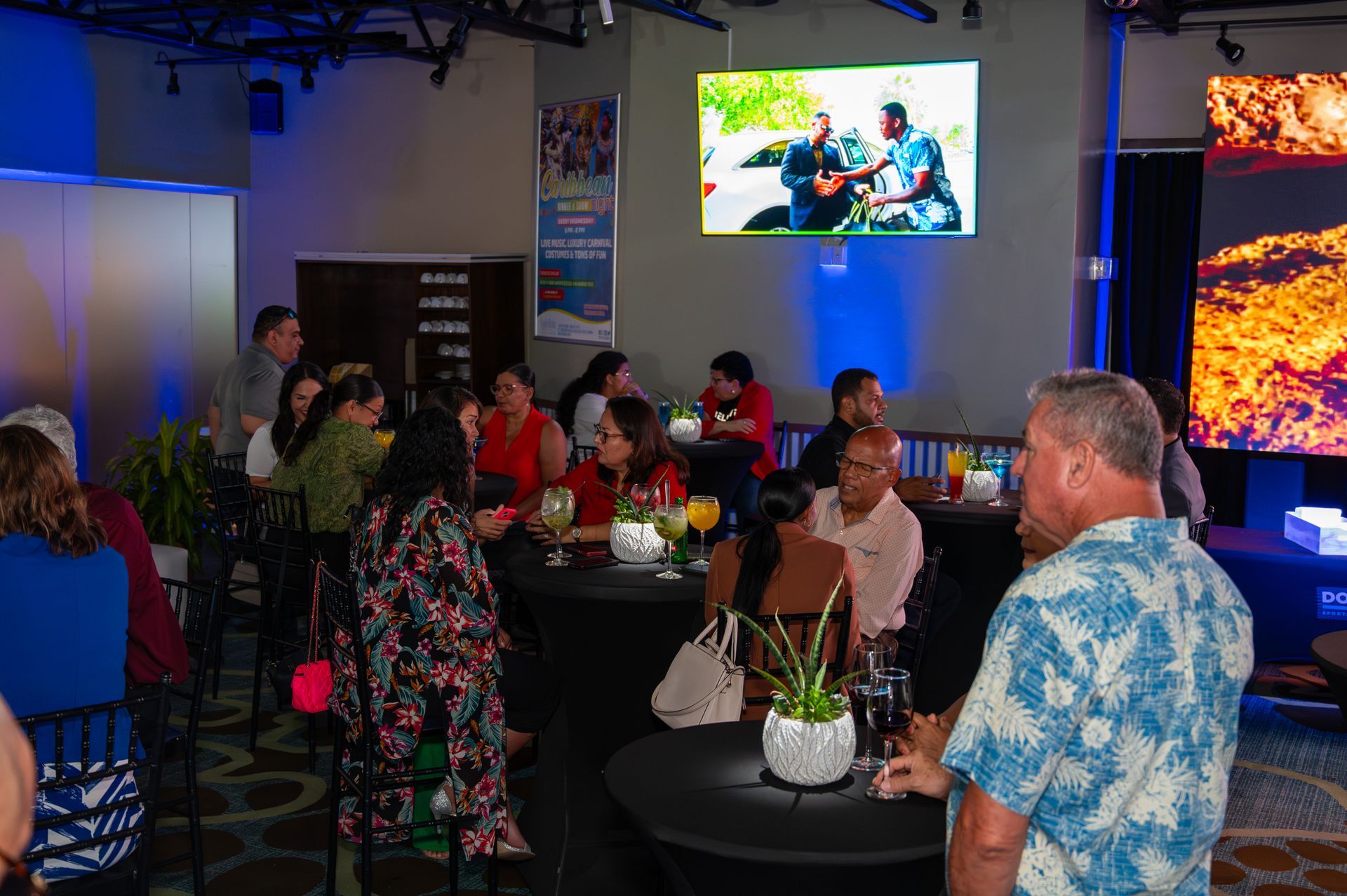 A group of people are sitting at tables in a room.
