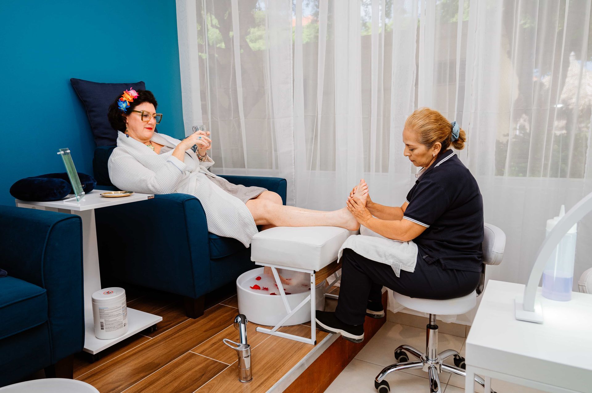 A woman is getting her feet massaged in a spa.