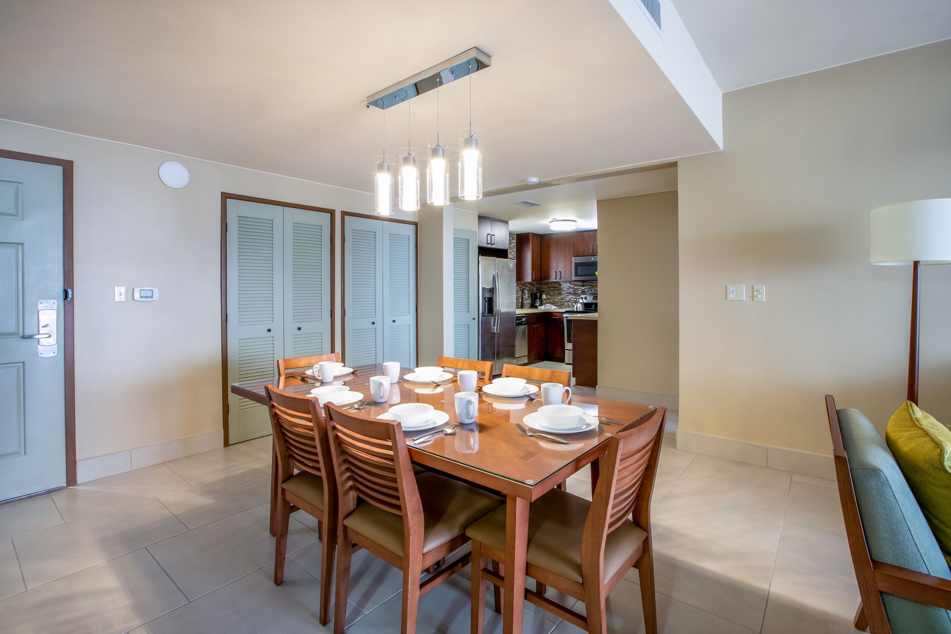 A dining room with a table and chairs and a chandelier.