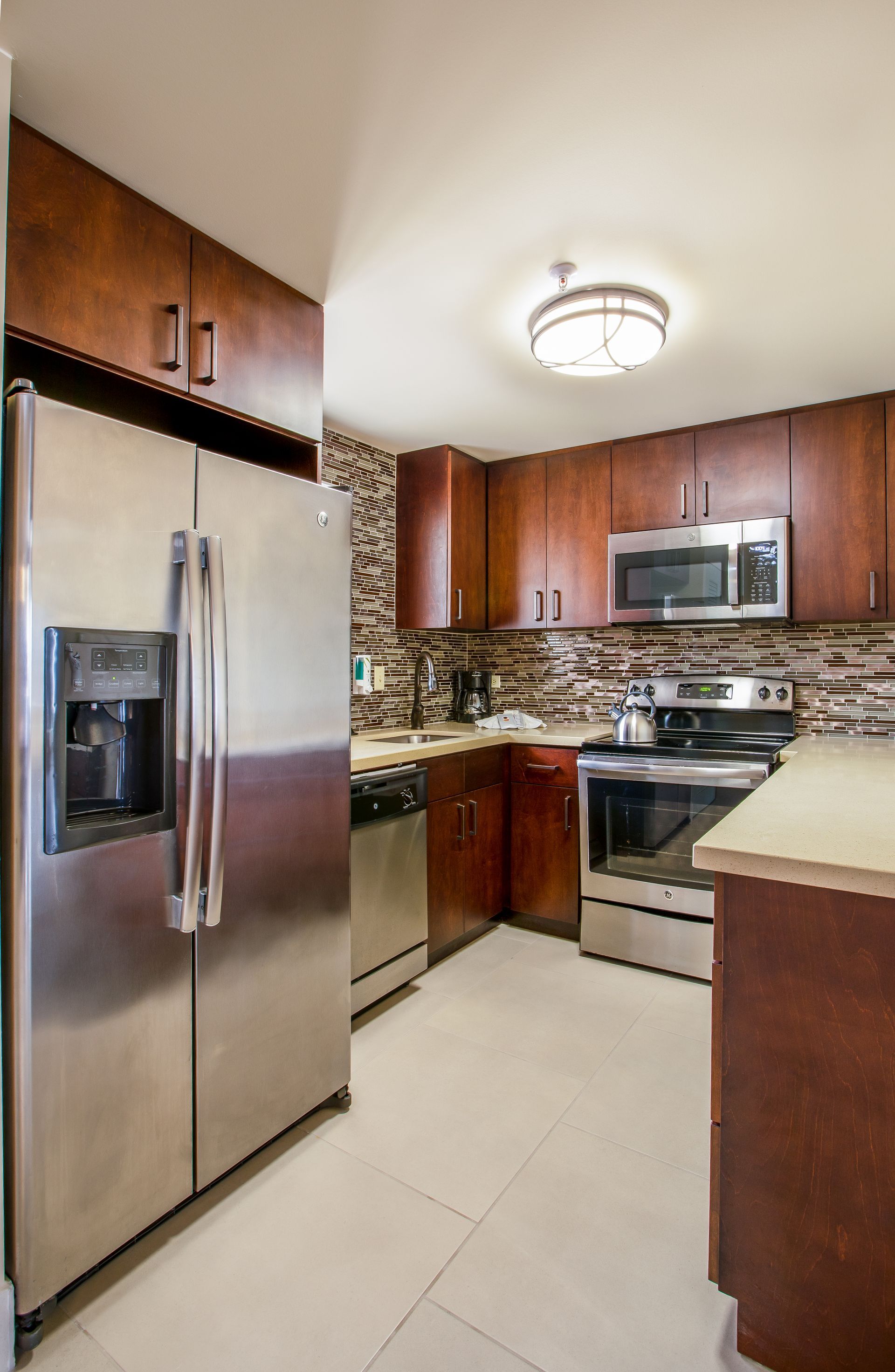A kitchen with stainless steel appliances and wooden cabinets