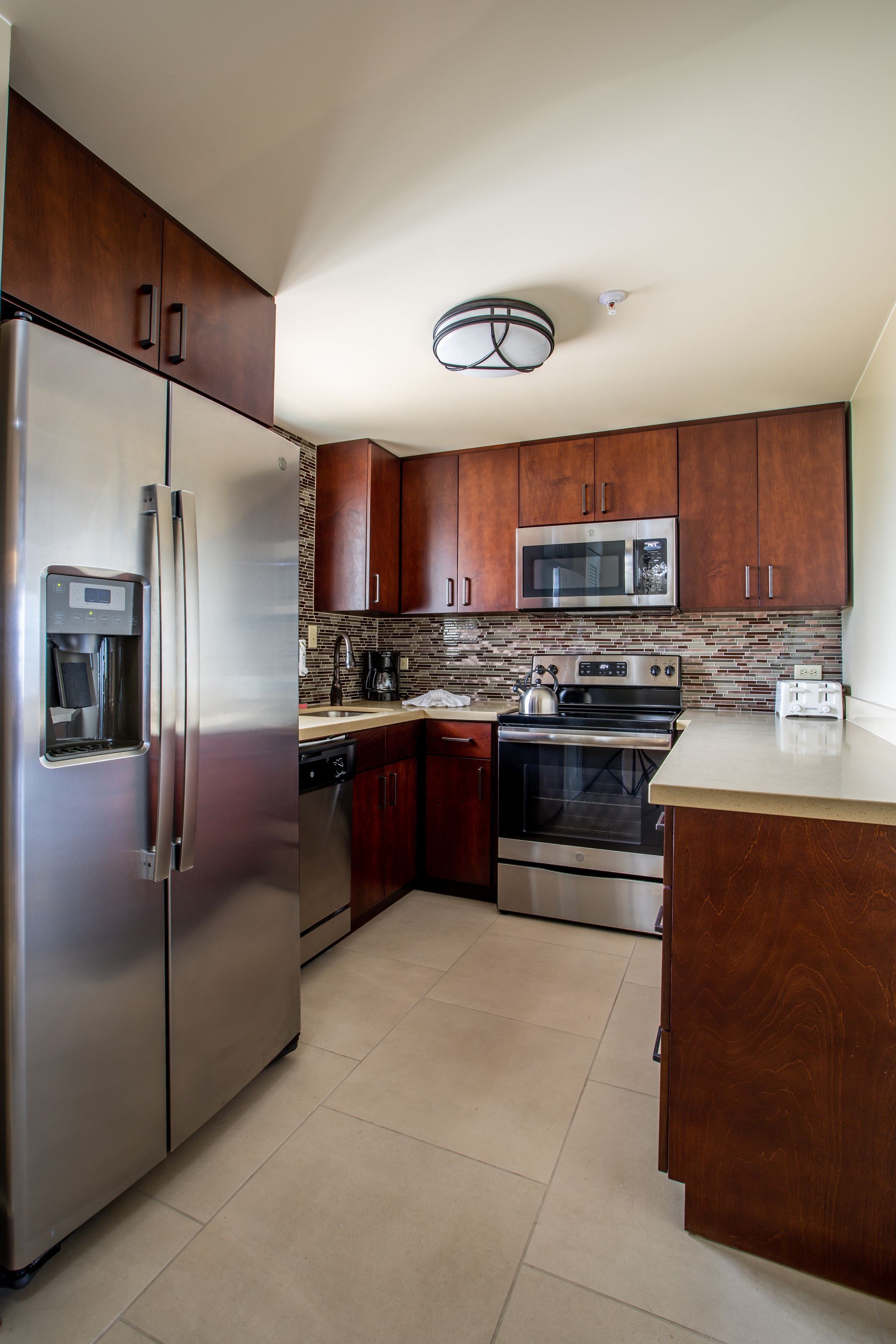 A kitchen with stainless steel appliances and wooden cabinets