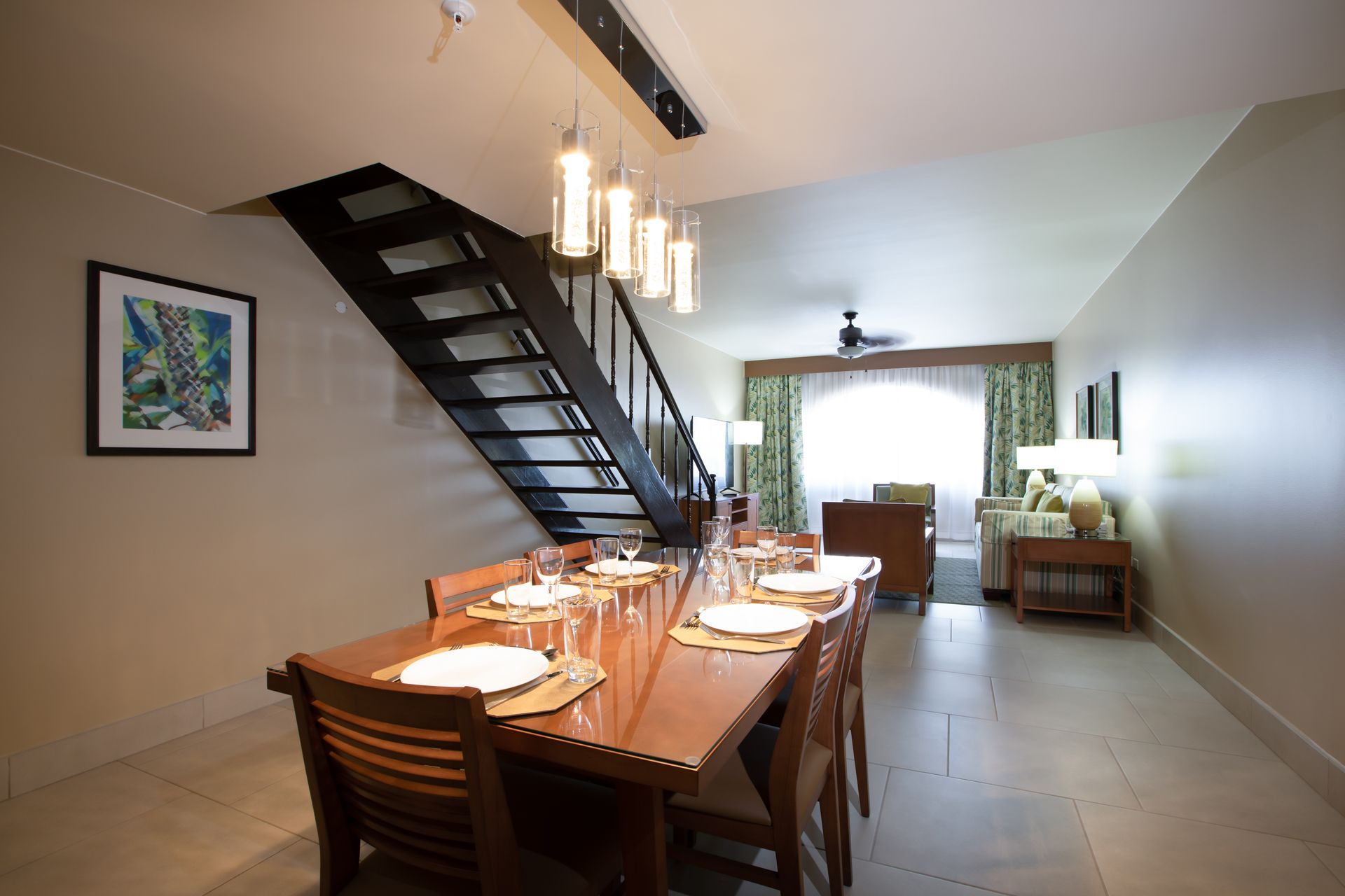 A dining room with a table and chairs and stairs