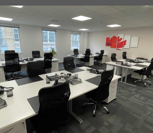 A large office with lots of desks and chairs