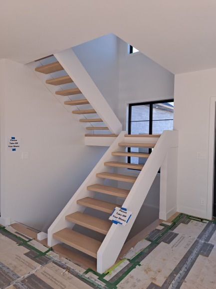 A wooden staircase in a house under construction
