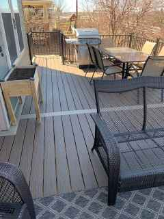There is a table and chairs on the deck.