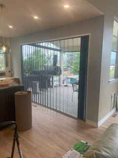 A living room with a sliding glass door leading to a patio.