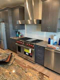 A kitchen with stainless steel appliances and granite counter tops.