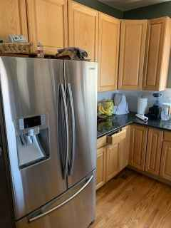 A kitchen with stainless steel appliances and wooden cabinets.