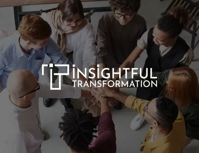 A group of people putting their hands together in a circle.