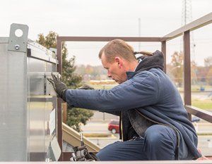 System Repair — Man Checking the HVAC in Nashville, TN