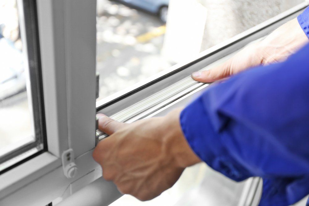 Worker Installing New Lock on Sliding Window — Door Lock Replacements in Launceston. TAS