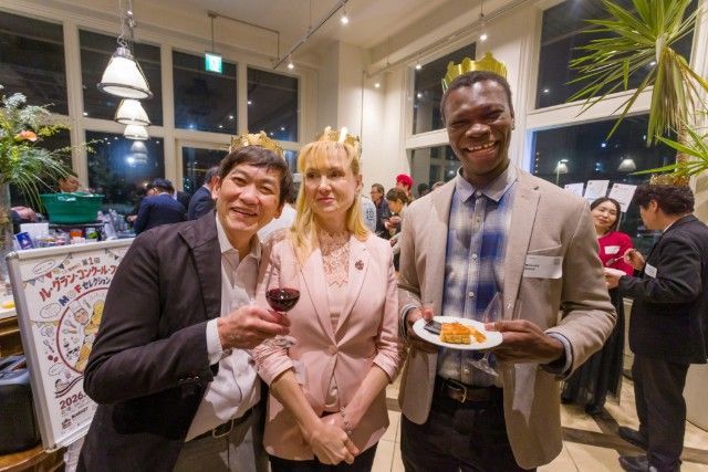 Guests wearing paper crowns after finding the fève in the Galette des Rois cake