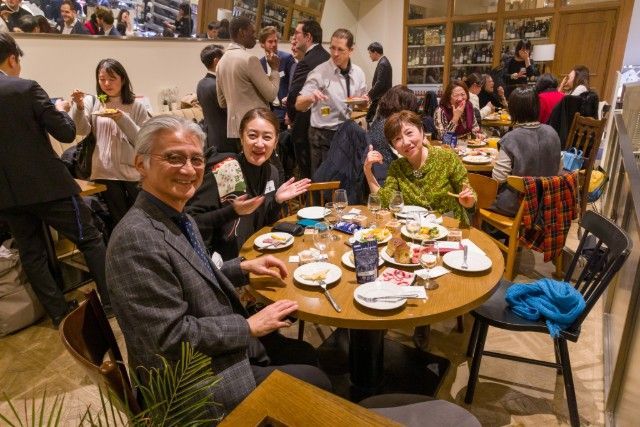 Guests enjoying dinner and conversation during the international New Year gathering