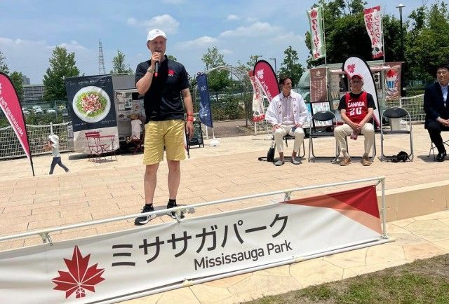 TJCS President Shoji Amano speaking on stage at a Mississauga Fair in Kariya, Japan.