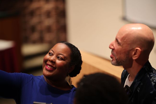 Philomena talking to a businessman at a conference