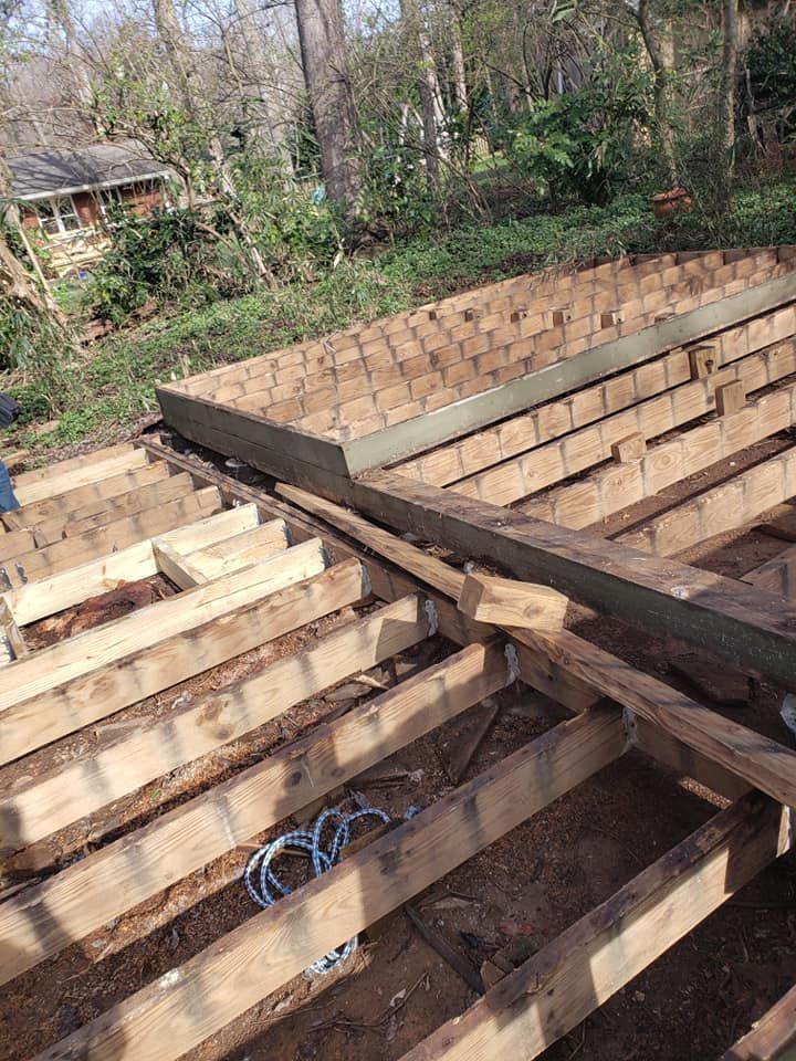 A wooden deck is being built in the woods.