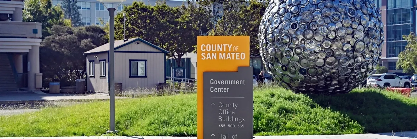 A sign that says county services is in front of a building.