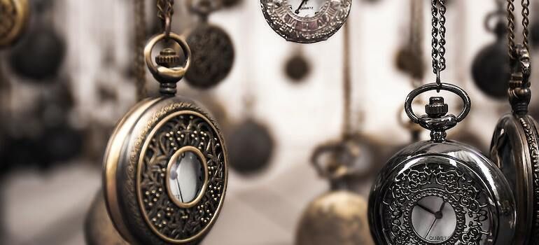 Several pocket watches hanging from above