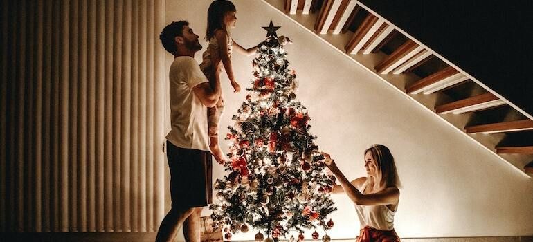 A family decorating their Christmas tree