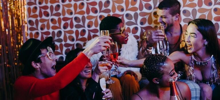A group of people are toasting with champagne glasses at a party.