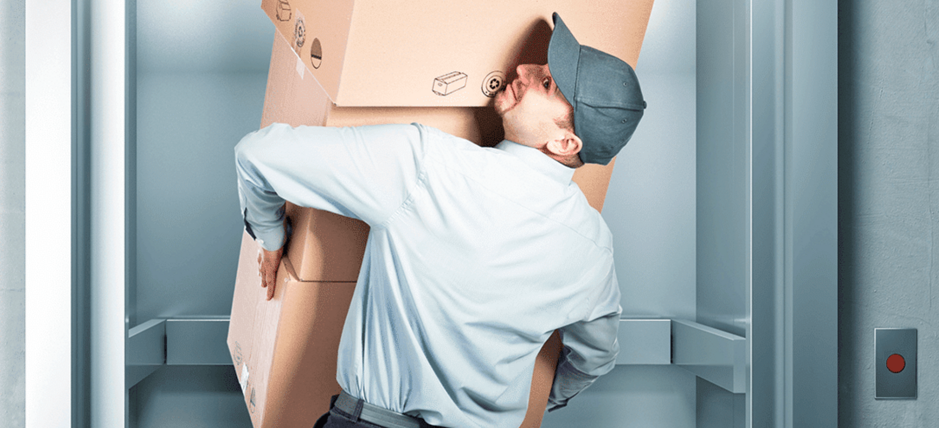 Man carrying boxes to load into an elevator