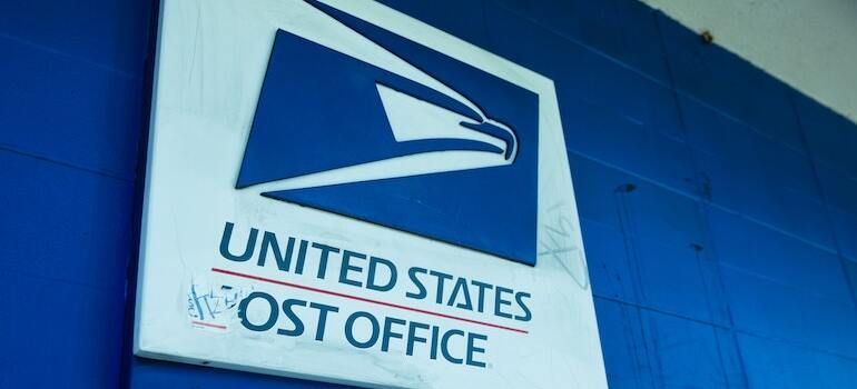 A United States post office sign on a wall
