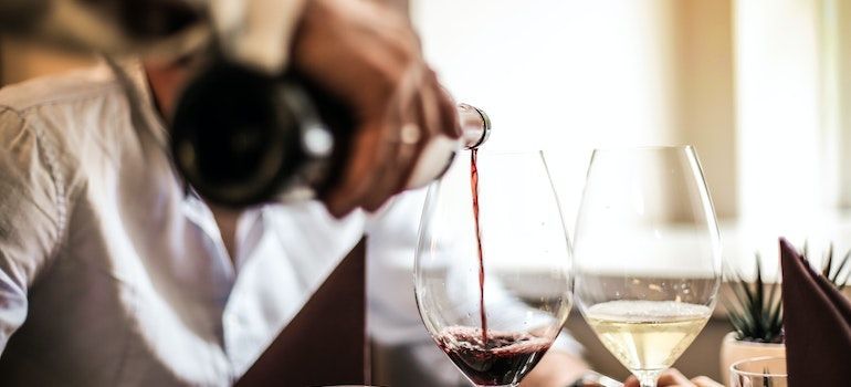 person enjoying wine in luxury restaurant after relocating to Atherton 