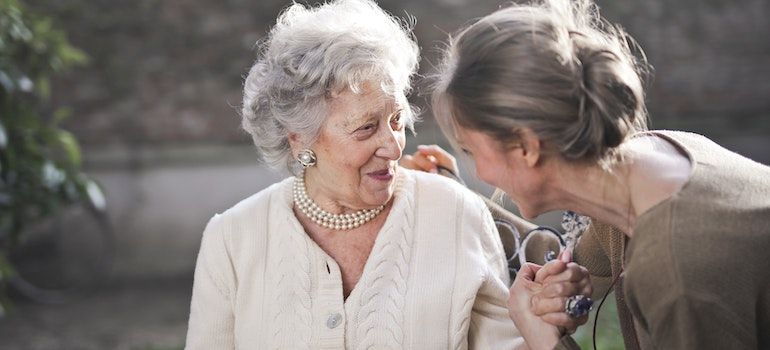 picture of a senior woman and a younger woman talking