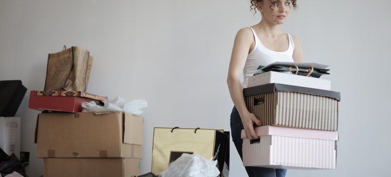 a woman carrying boxes