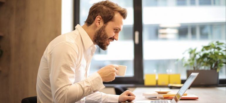 Man using a laptop to research the best places in Bay Area for job seekers