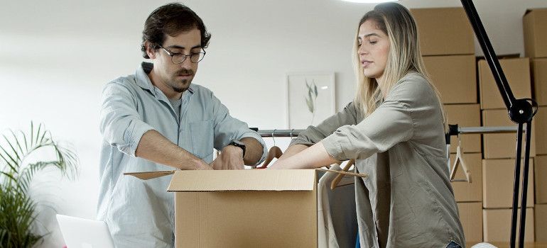 Young couple packing a box together