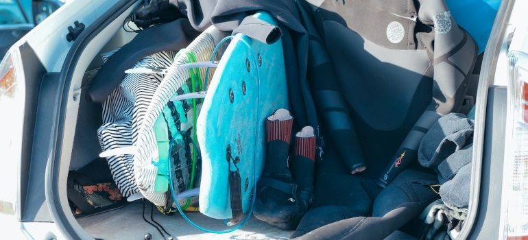 Surfboard and other spot equipment in the trunk.