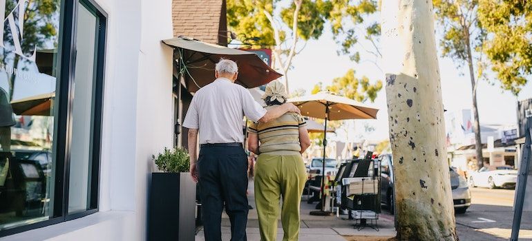 An elderly couple walking;