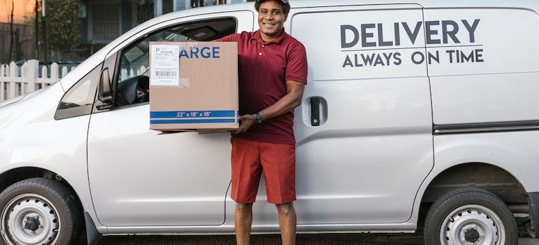 A delivery guy holding a box