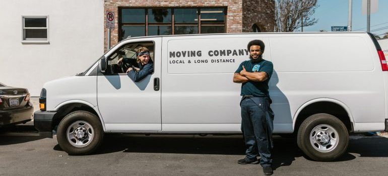 Moving company employees with their moving van.