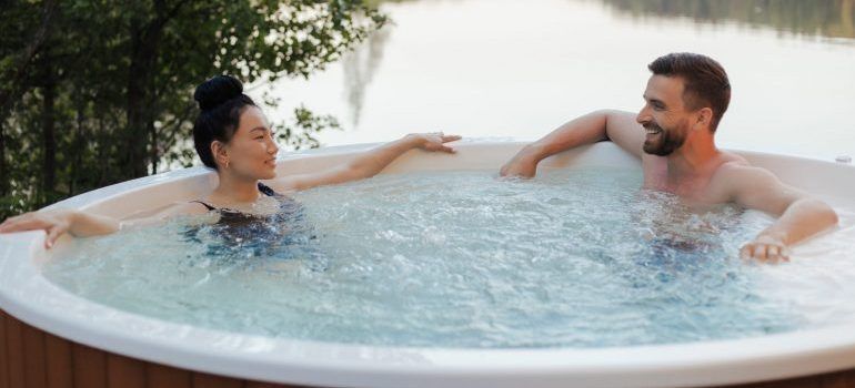 A man and woman relaxing in a hot tub