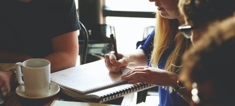 Person writing on the notebook