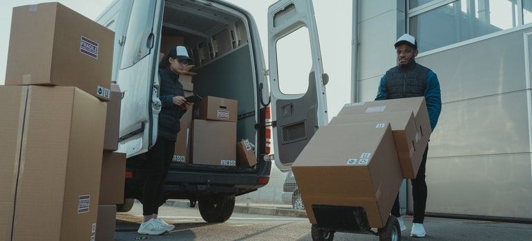 Two workers unloading the moving boxes