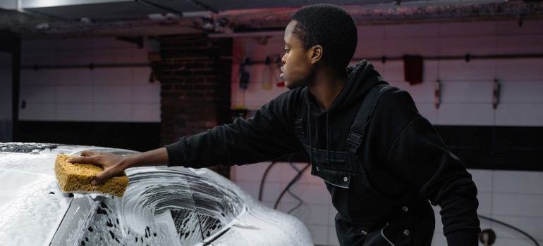 man washing car