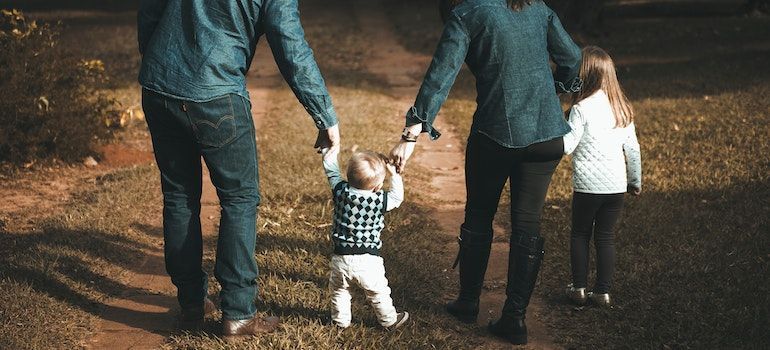 Parents walking with their child.