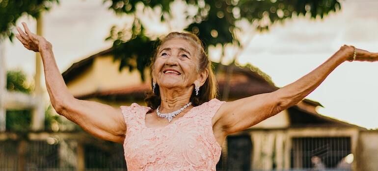 A happy senior woman dancing