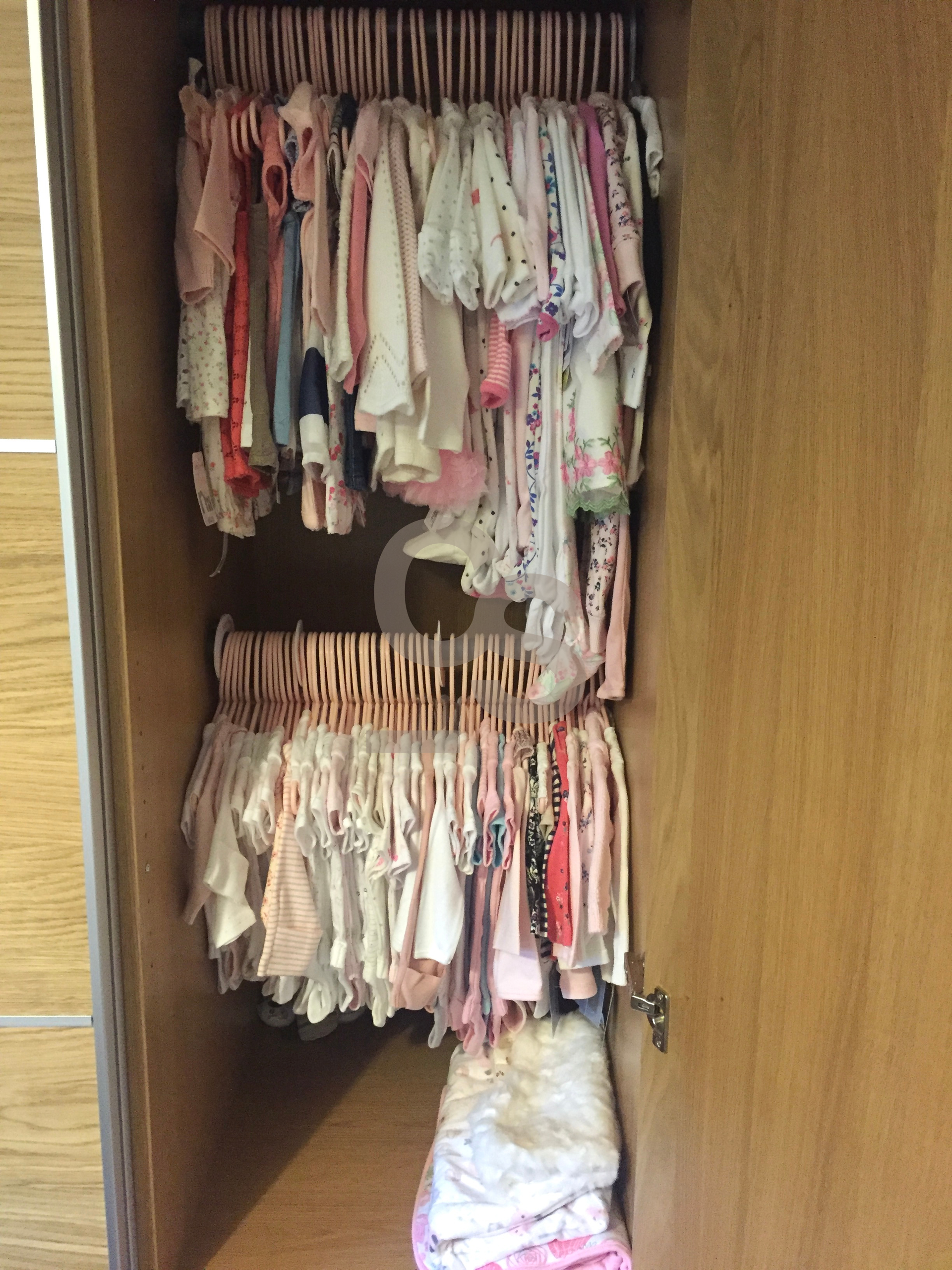 Organised wardrobe of baby clothes